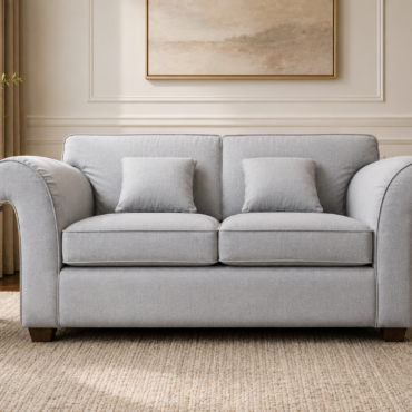 Victoria Love Seat handcrafted with a premium solid teak wood frame, soft light grey fabric upholstery, elegant rolled arms, and deep comfortable seating.
