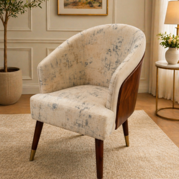 Luna Accent Chair handcrafted from solid teak wood featuring a curved upholstered back, exposed wood exterior, textured fabric upholstery, and tapered wooden legs with brass-finished caps.