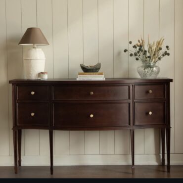 Hampton Console Table handcrafted from premium solid teak wood featuring a graceful curved front, six spacious storage drawers, tapered legs, and a rich hand-finished wood finish for elegant entryways, hallways, and living spaces.